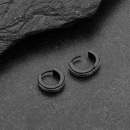 Black viking rune hoop earrings on a dark textured surface