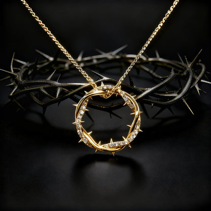 Gold Crown Of Thorns Pendant necklace with a circular pendant on a dark background