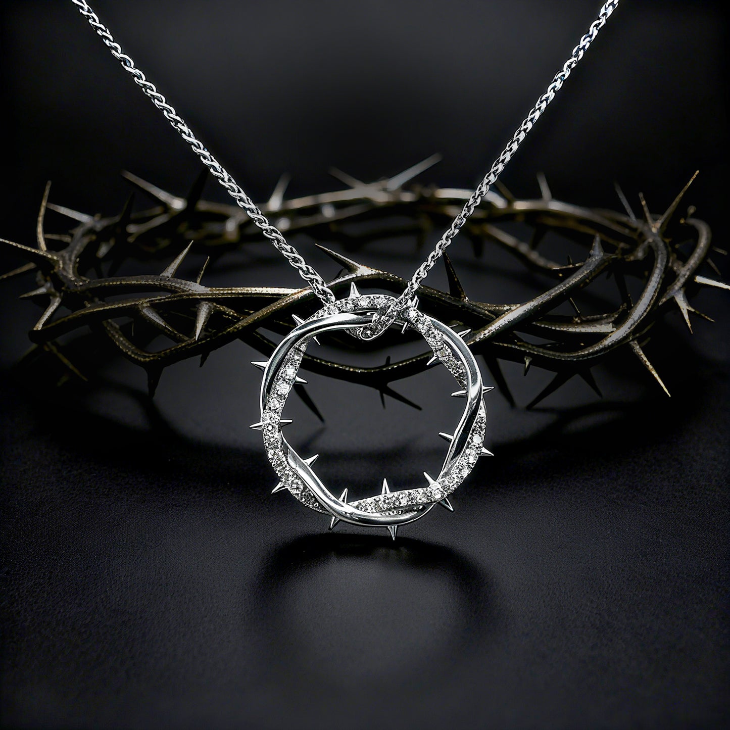 Silver Crown Of Thorns Pendant necklace with a circular pendant on a dark background
