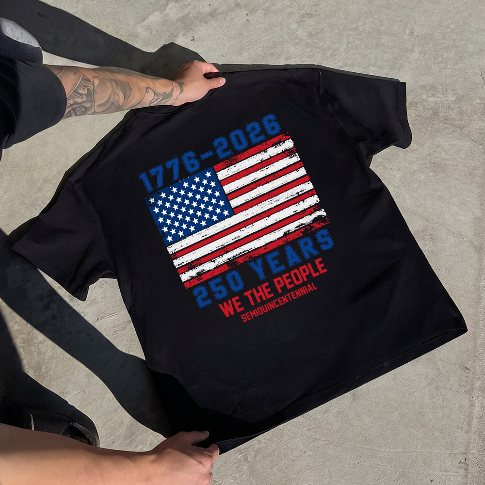 Black t-shirt with American flag design and text on a concrete surface
