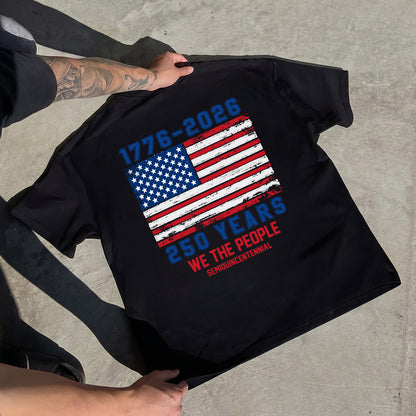 Black t-shirt with American flag design and text on a concrete surface