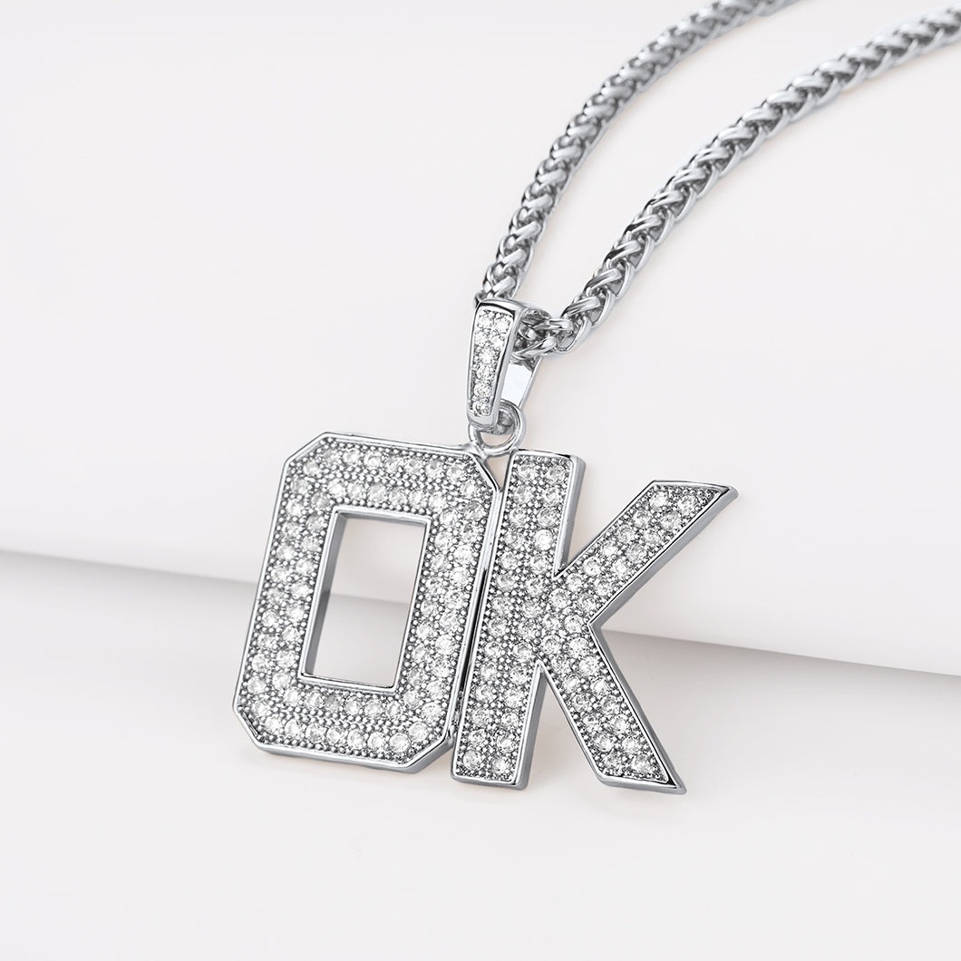 Silver 'OK' pendant necklace on a white background