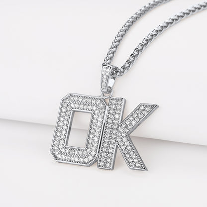 Silver 'OK' pendant necklace on a white background