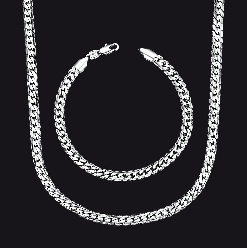 A silver Cuban link chain necklace and matching chain bracelet.