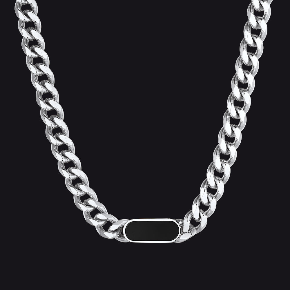 Silver chain necklace with a tag on a black background