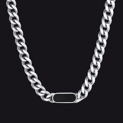 Silver chain necklace with a tag on a black background