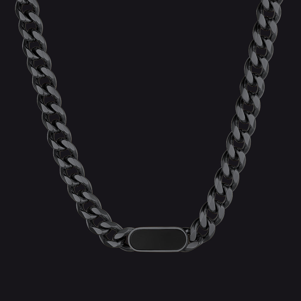Black chain necklace with a rectangular tag on a black background
