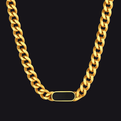 Gold chain necklace with a rectangular tag on a black background