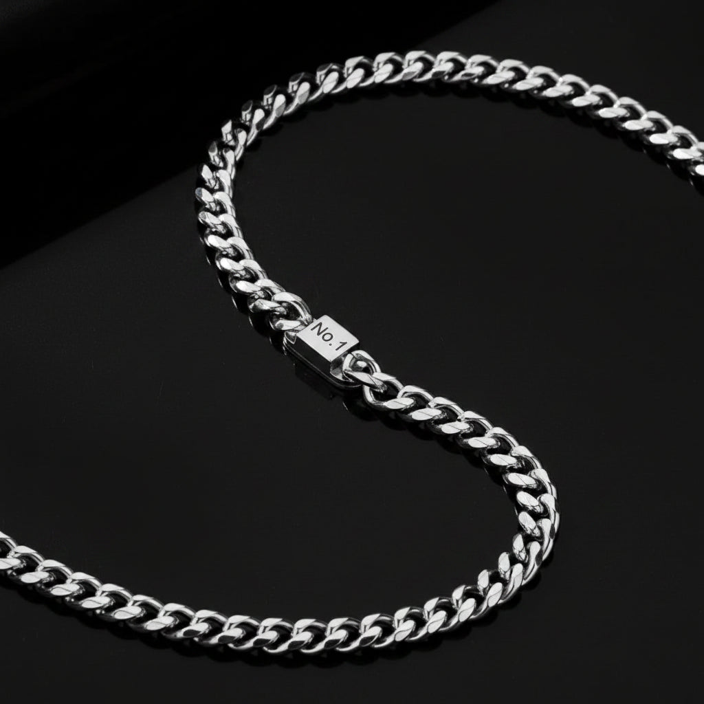 Silver chain necklace on a gray surface