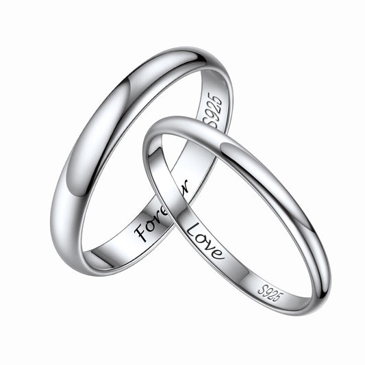 Two silver rings interlocked with 'Forever Love' engraving on a white backgroundimg