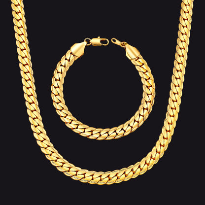 Gold chain necklace and bracelet on a black background