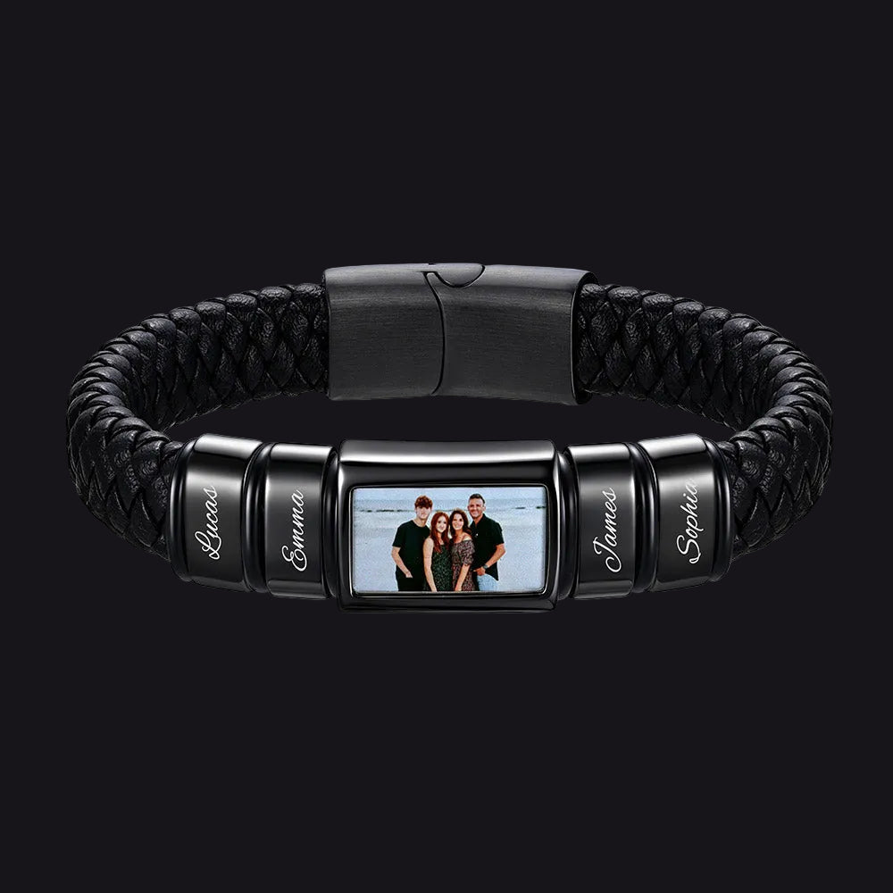 A personalized black braided leather and metal bracelet featuring a central rectangular photo frame and four engraved name beads shown on a plain white background.