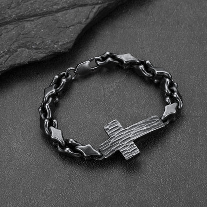 Close-up of black geometric cross diamond cut chain links, detailed gothic bracelet for men