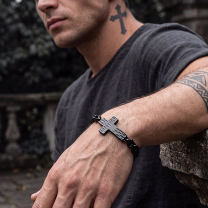 Man wearing all black cross gothic geometric diamond link chain bracelet, front wrist view, black cross link bracelet for men