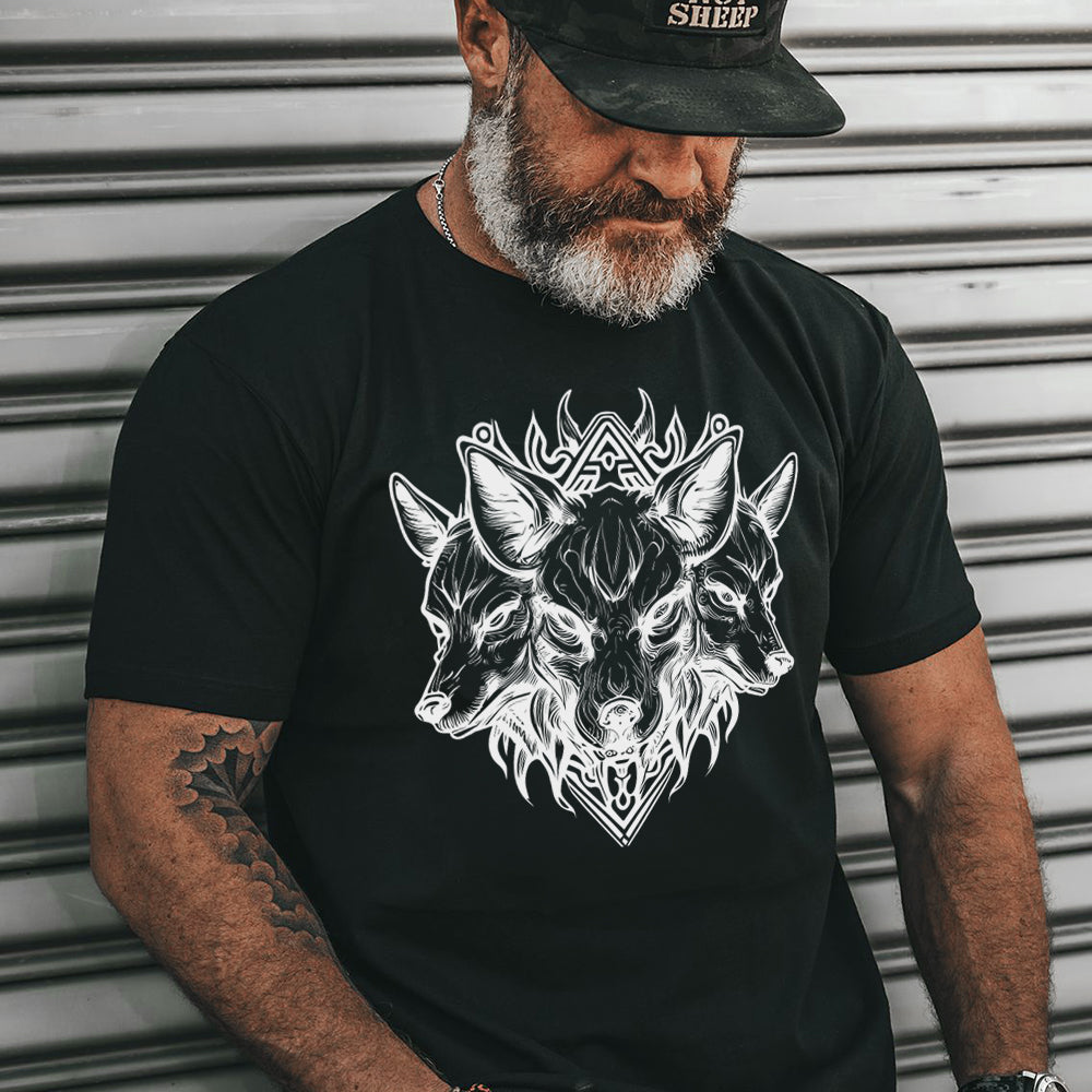 Man wearing a black t-shirt with a white wolf design against a metallic background