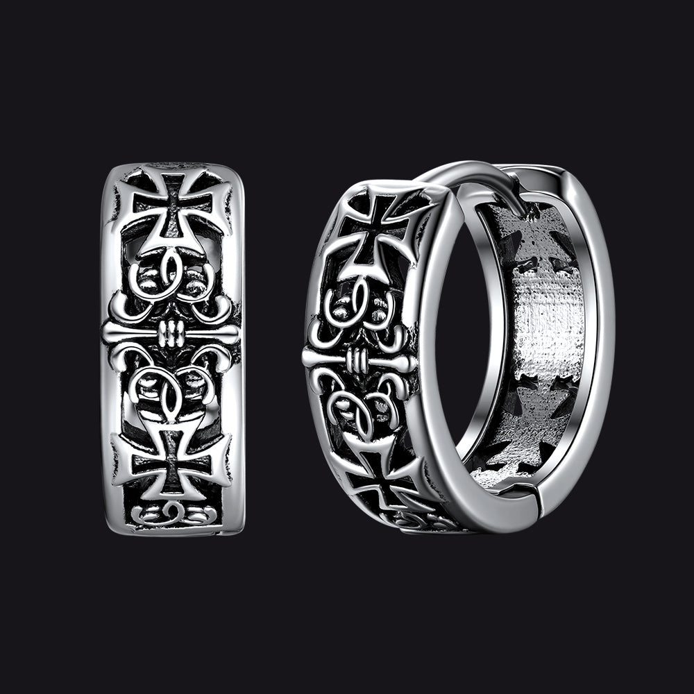 Silver hoop earrings with cross designs on a black background