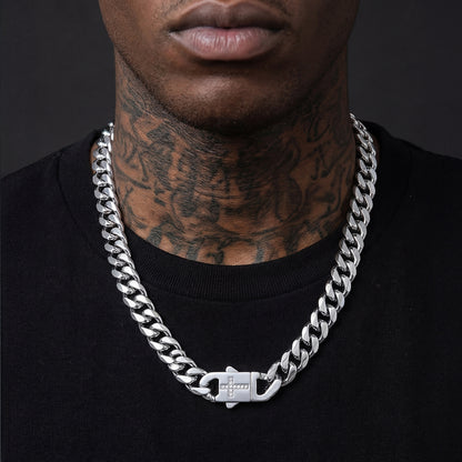 Man wearing a silver chain necklace with a dark background