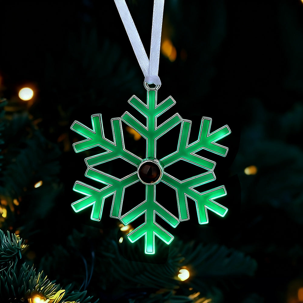 Green snowflake ornament on a dark background with blurred lights