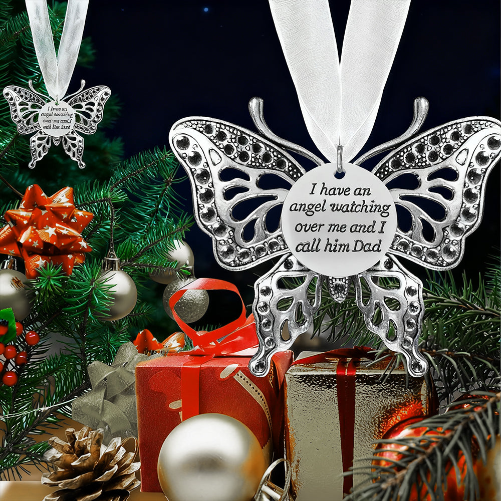 Butterfly ornament with sentimental message on a Christmas tree with decorations.