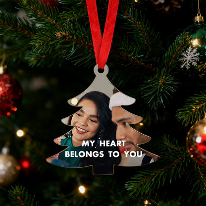 Personalized Christmas ornament with two people's faces and 'My Heart Belongs to You' text on a tree.
