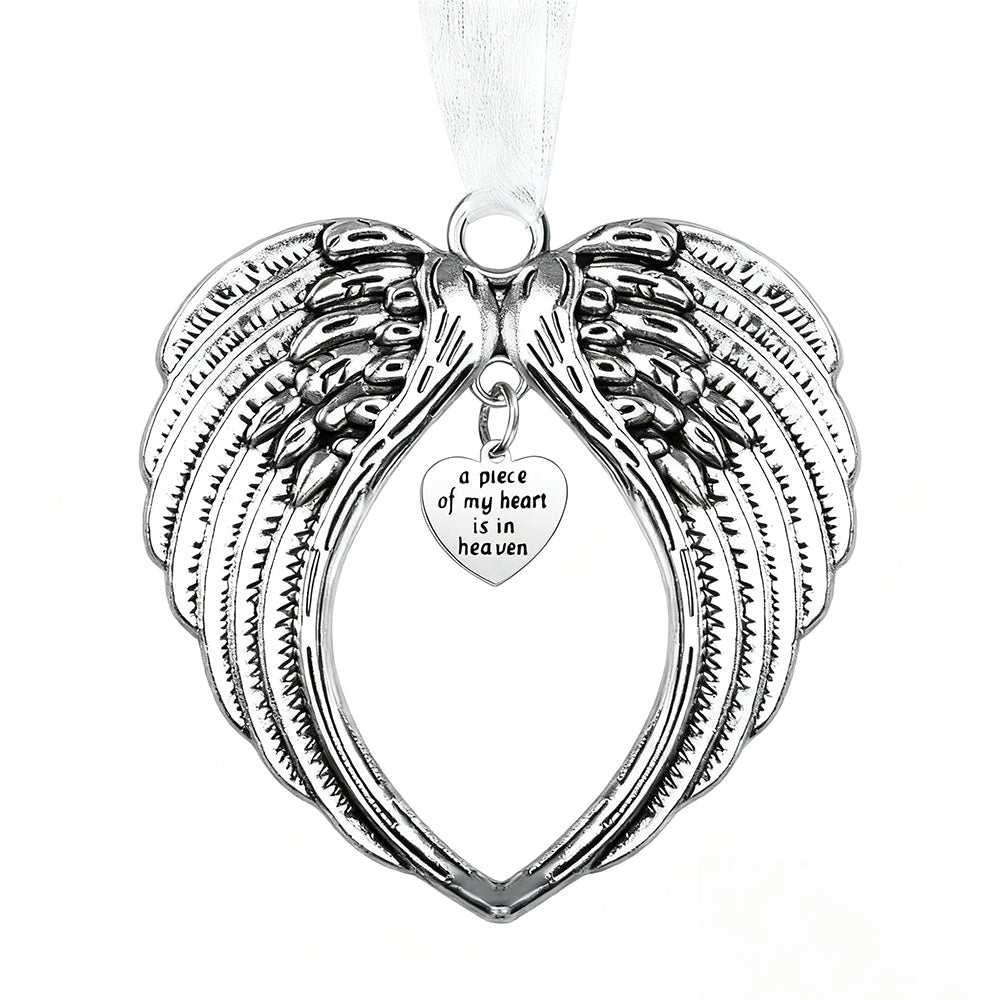 Silver angel wing pendant with heart-shaped tag on a white background