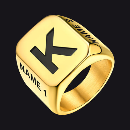 Gold ring with a black letter 'K' on a black background