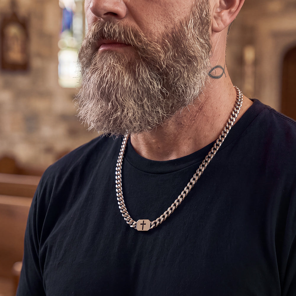 Man styling Bible verse cross Cuban chain with T-shirt