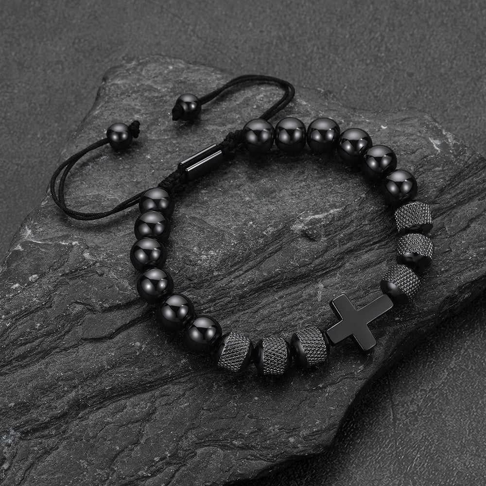 Close-up of black obsidian cross-shaped beads, detailed natural stone cross bracelet for men