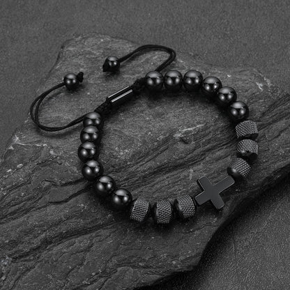 Close-up of black obsidian cross-shaped beads, detailed natural stone cross bracelet for men