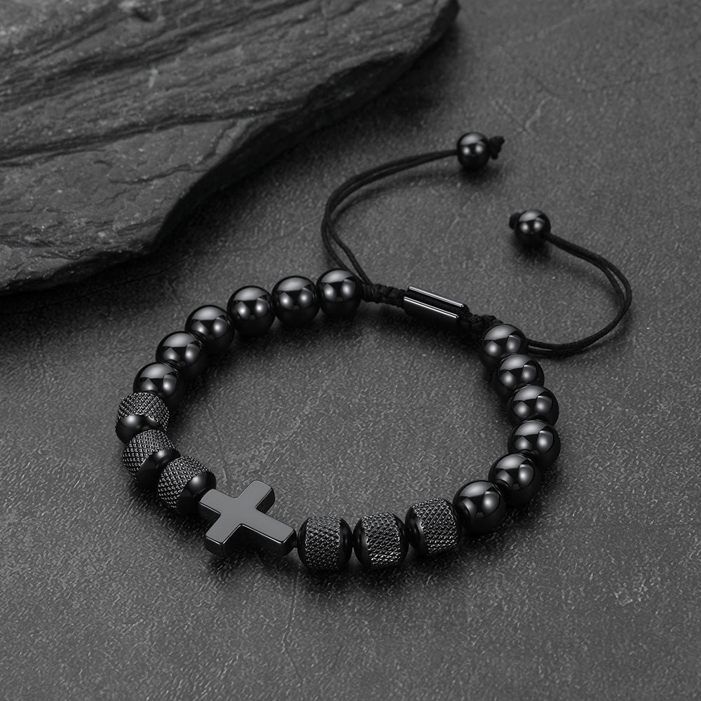 A black beaded bracelet with a small black cross.