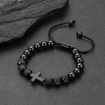 A black beaded bracelet with a small black cross.