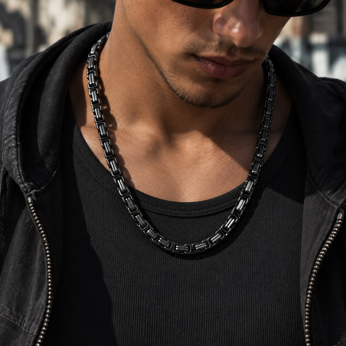 Man styling Byzantine link chain necklace with casual shirt
