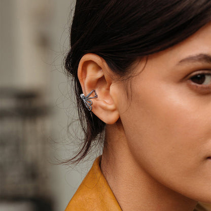 Close-up of a woman's ear wearing a silver earring 