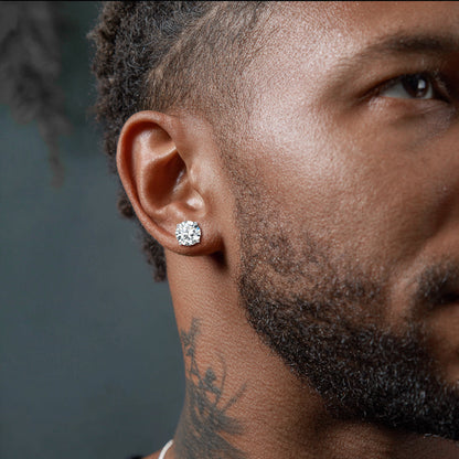 Close-up of a man wearing a diamond earring with a dark background