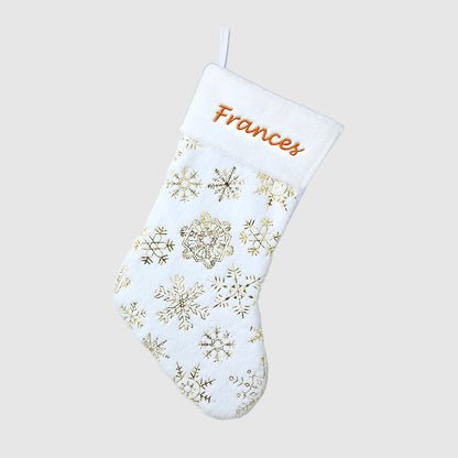 White Christmas stocking with gold snowflake patterns and 'Frances' embroidered on a light gray background