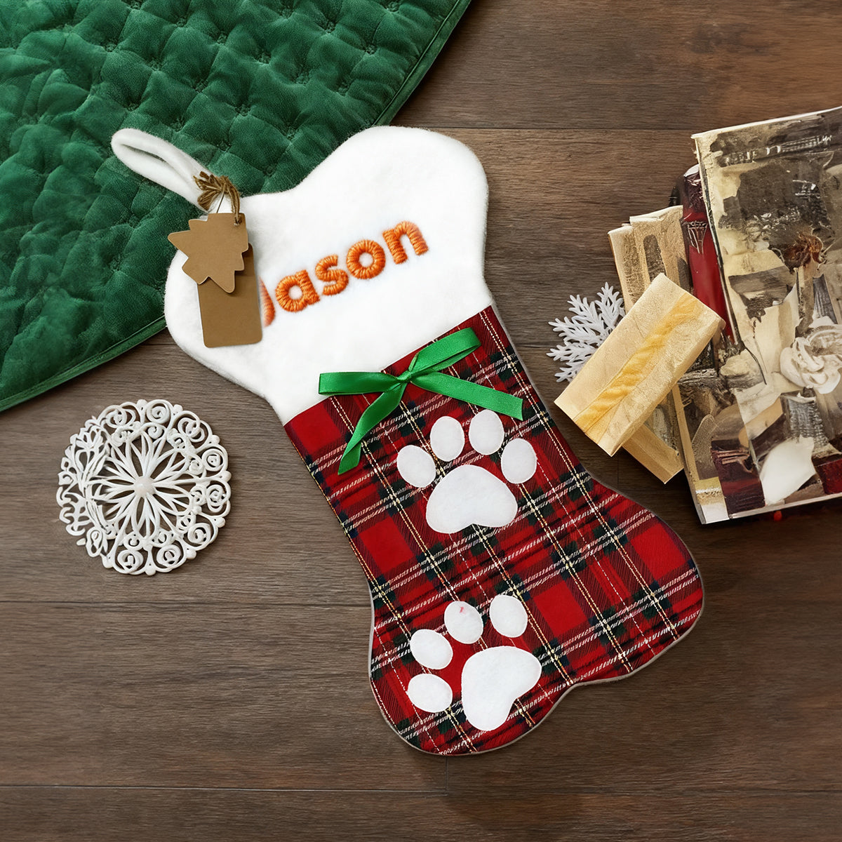 Personalized dog stocking with plaid pattern and paw prints on a wooden surface.