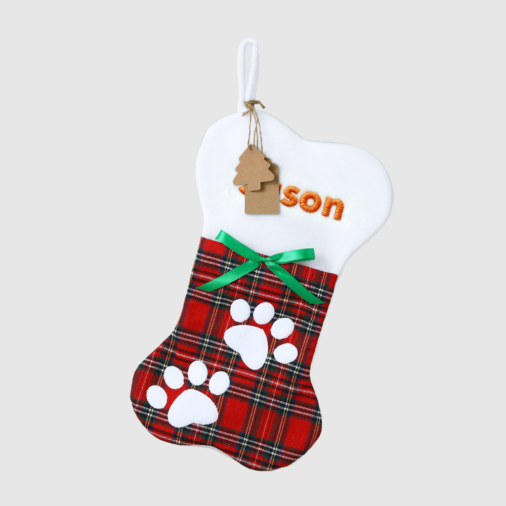 Plaid pet stocking with paw prints and 'son' tag on a white background