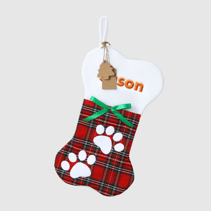 Plaid pet stocking with paw prints and 'son' tag on a white background