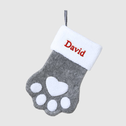 Gray paw print stocking with white cuff embroidered with 'David' on a light gray background