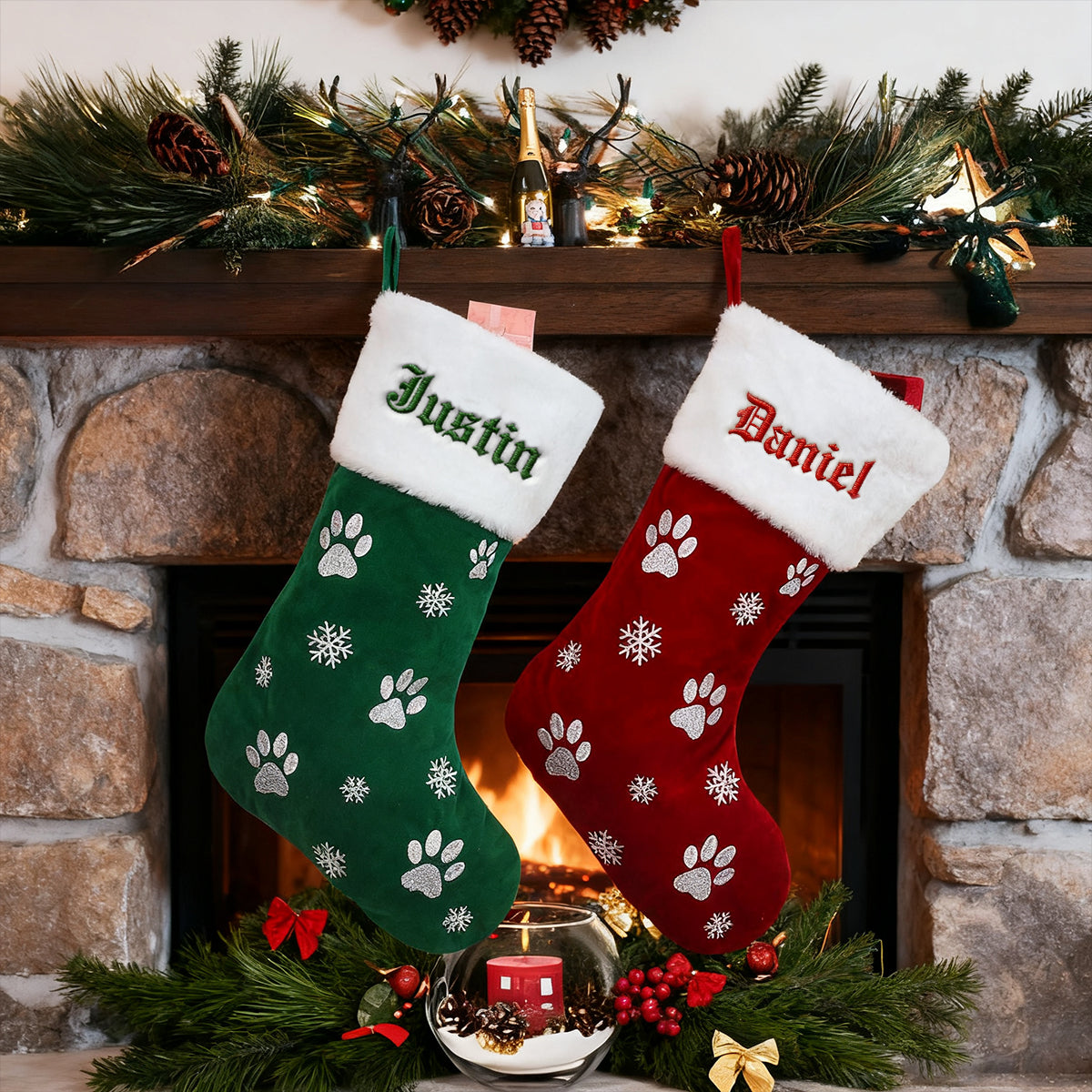 Two Christmas stockings, one green and one red, with names embroidered on them, hanging by a fireplace.