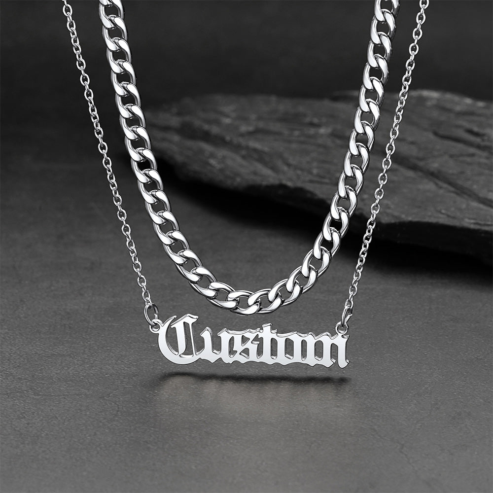 Silver chain necklace with 'Custom' pendant on a dark surface