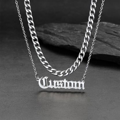 Silver chain necklace with 'Custom' pendant on a dark surface