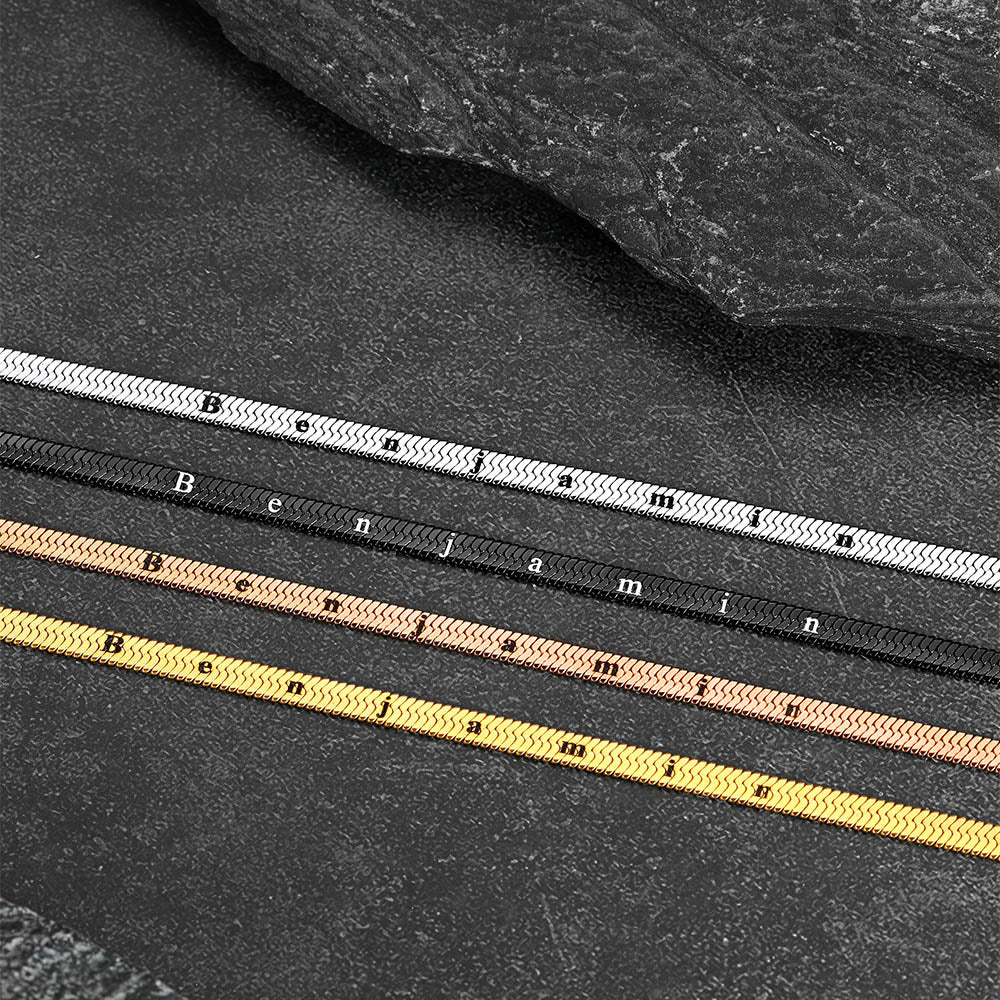 Three bracelets in silver, rose gold, and yellow gold on a dark surface.
