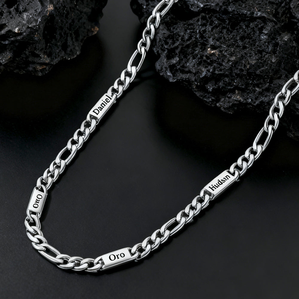 Silver chain necklace with engraved text on a dark stone background