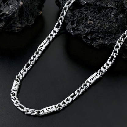 Silver chain necklace with engraved text on a dark stone background
