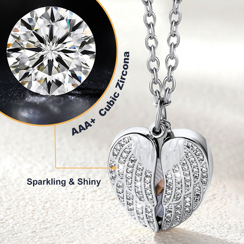 Silver angel wing pendant with AAA+ cubic zirconia on a light background