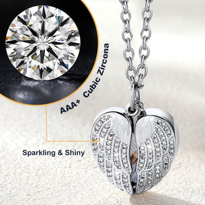 Silver angel wing pendant with AAA+ cubic zirconia on a light background