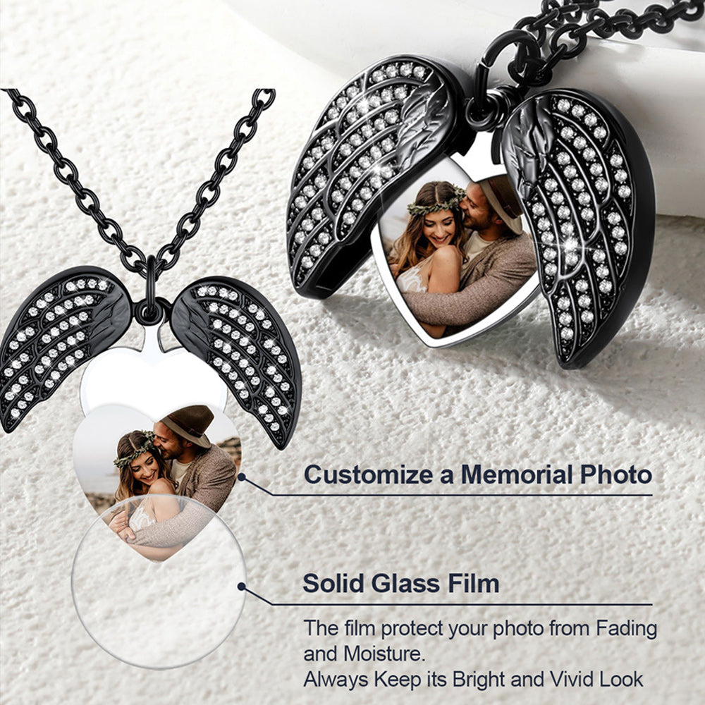 Black angel wing necklace with embedded photos on a white background