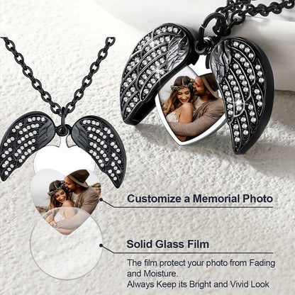 Black angel wing necklace with embedded photos on a white background