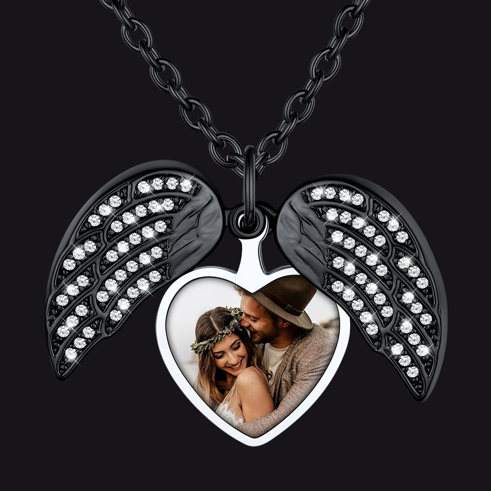 Necklace with angel wings and heart-shaped photo frame on a black background